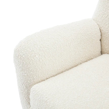 Poltrona club "Bouclé" con schienale ad ali, capitonné e gambe oblique in legno